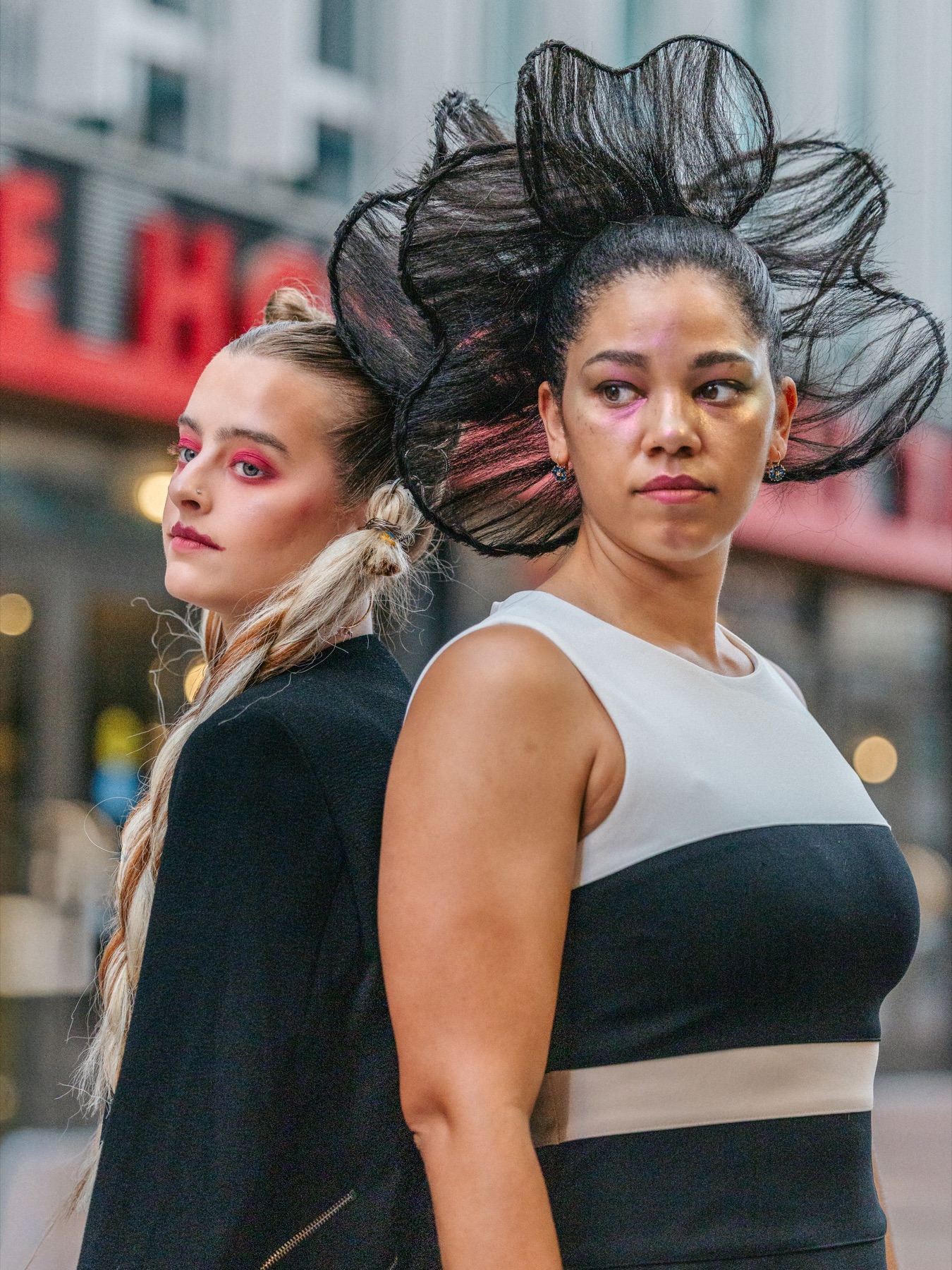Two models with sculptural hair and bold editorial makeup