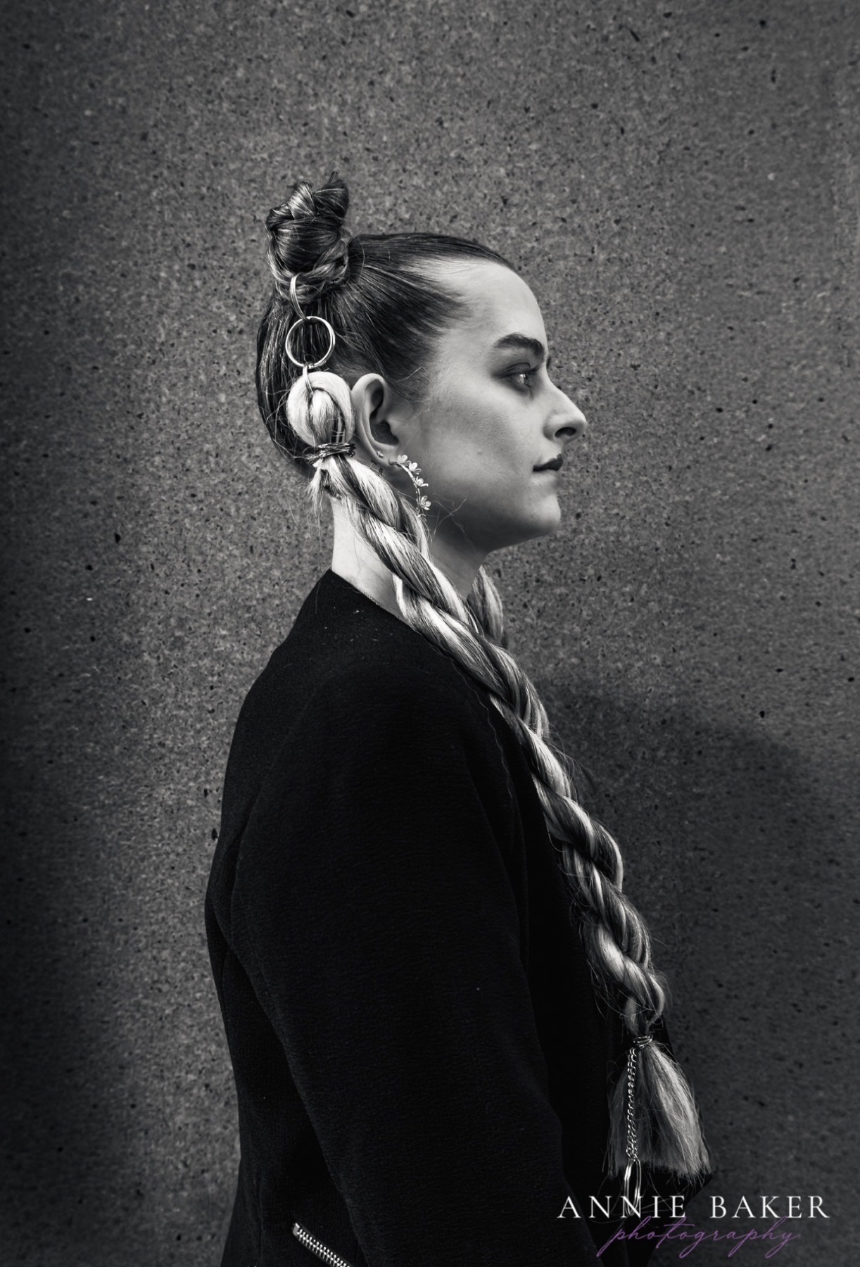 Black and white profile of editorial braids with hair rings