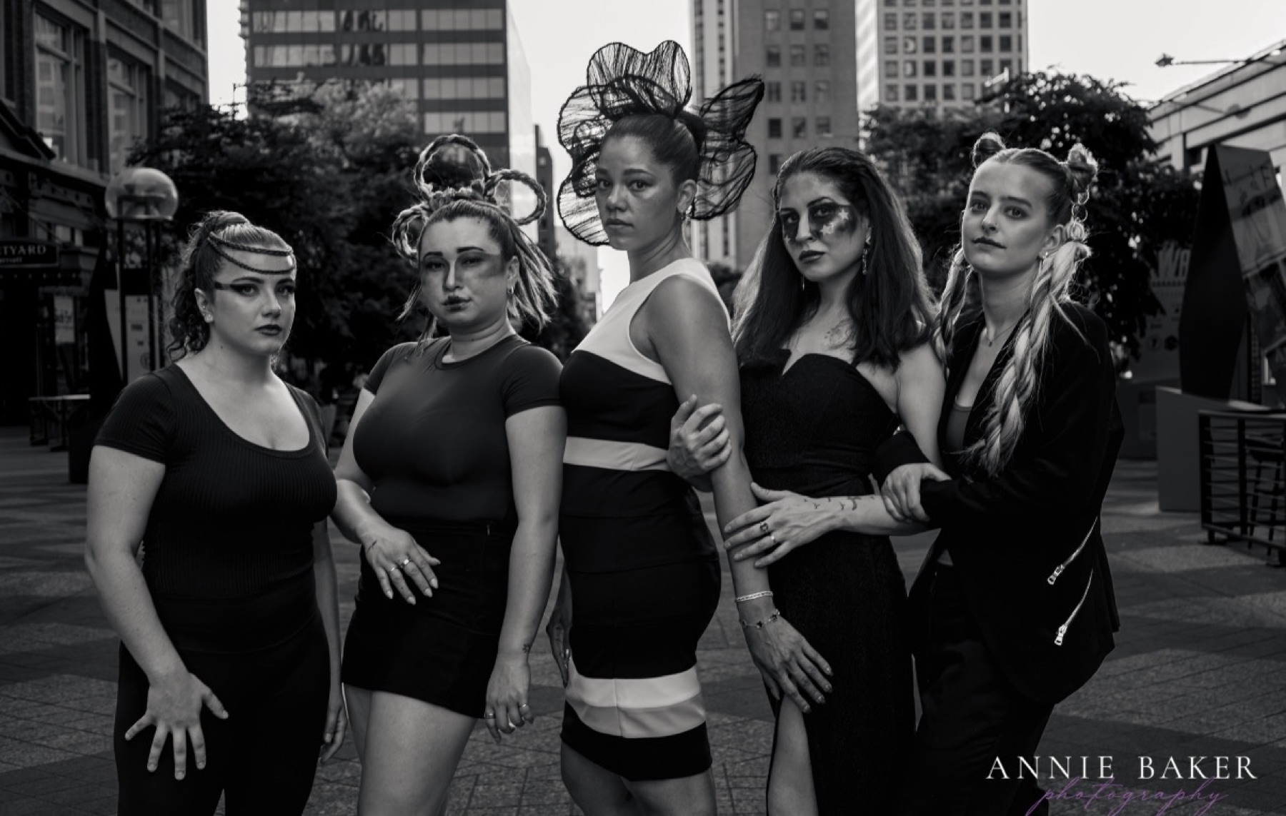 Group editorial street shoot with sculptural hair and dramatic makeup