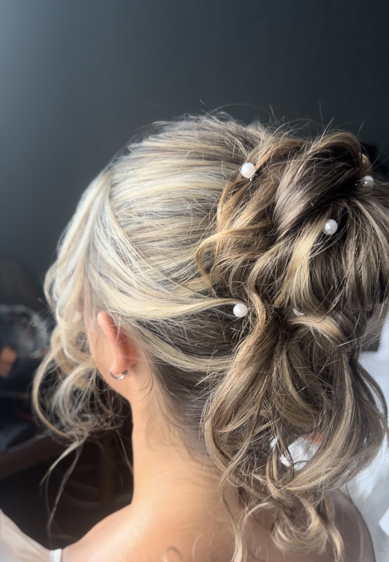 Textured blonde bridal ponytail with pearl pins