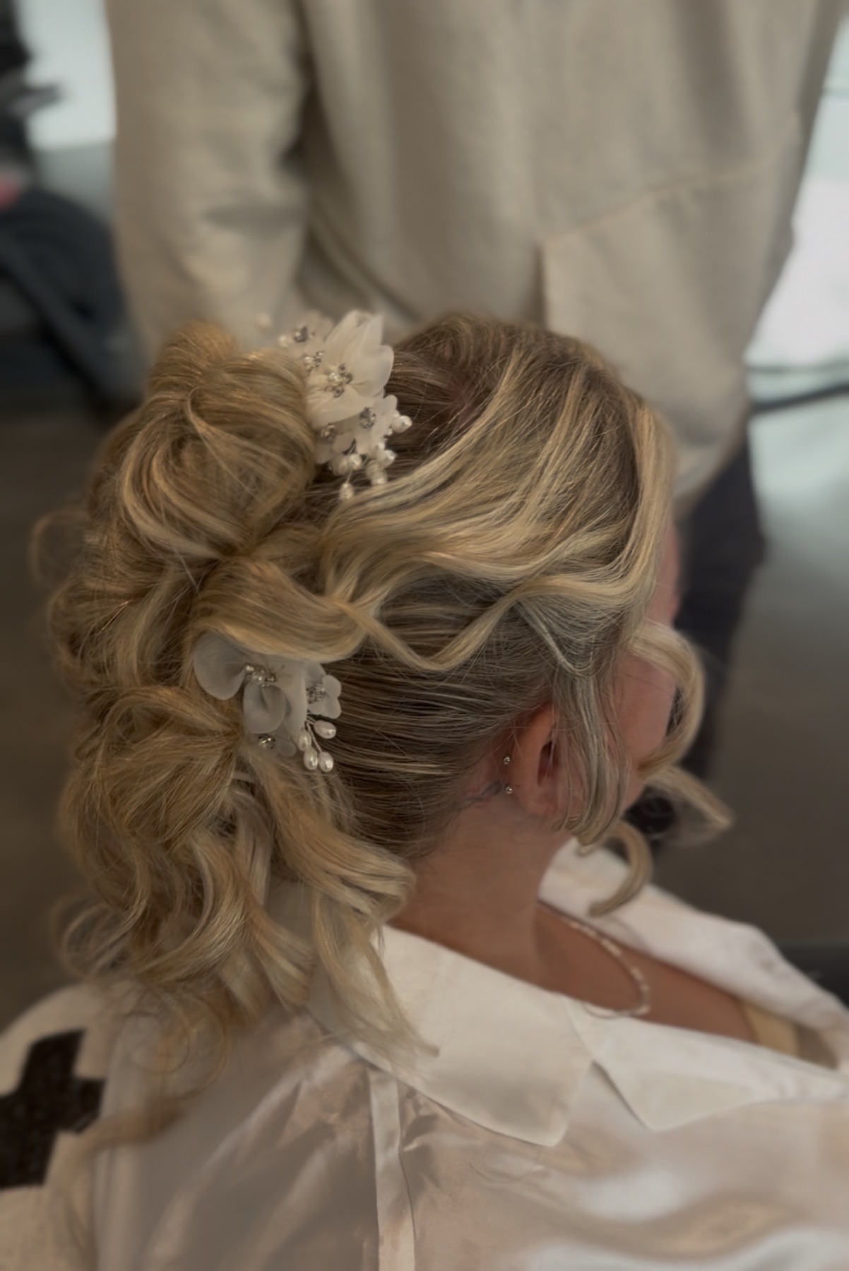 Romantic textured bridal updo with floral pins