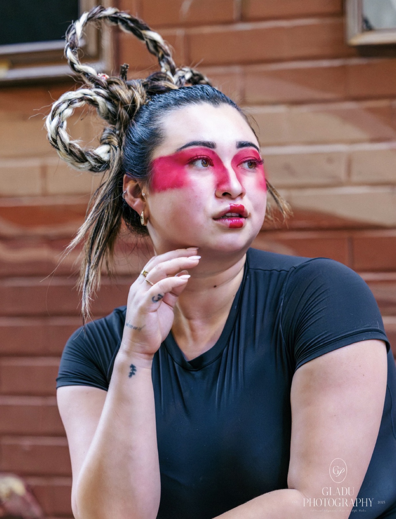 Red graphic editorial eye makeup with sculpted braided hair
