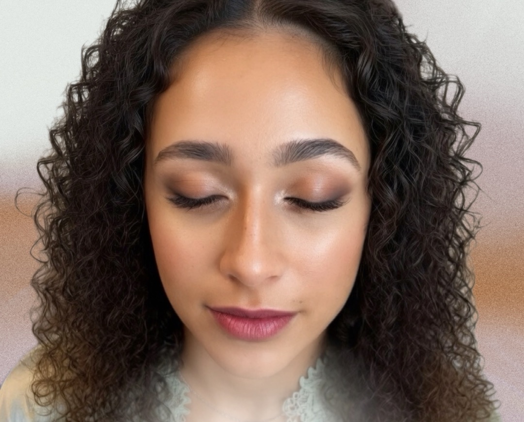 Warm bronze bridal eyes and berry lip on natural curls